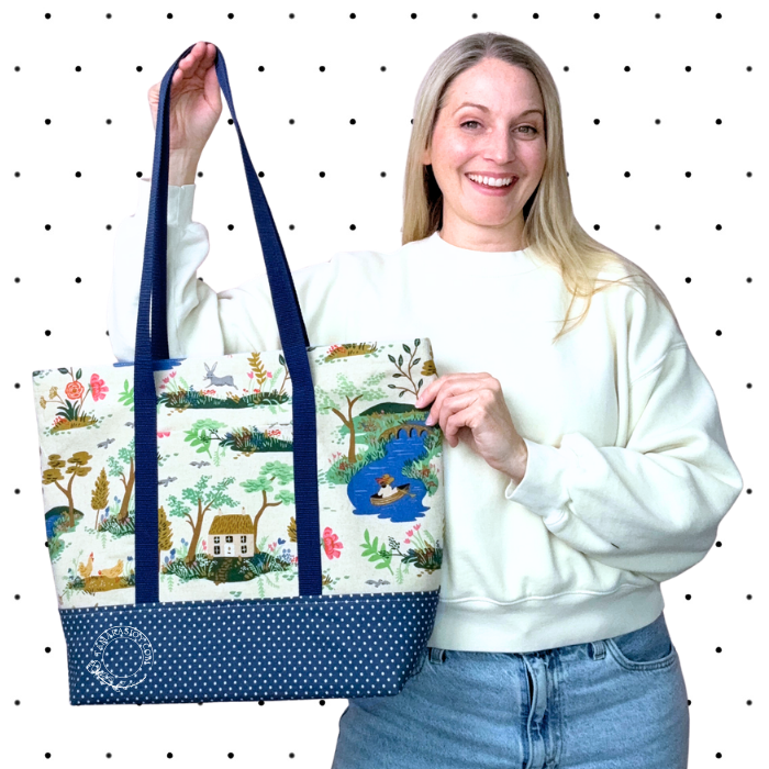 Woman holding a large tote bag with nature-themed design against a polka dot background