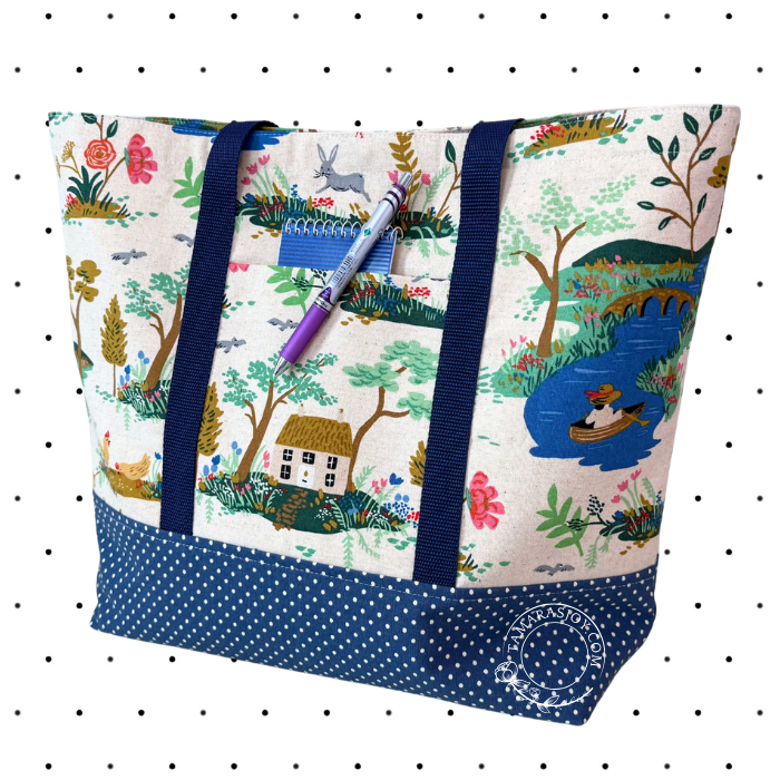 Tote bag with nature-themed design and blue polka dot trim on a white background
